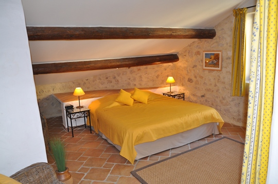 Mas des Oliviers at Moulin de la Roque, Noves, large Mastr bedroom, with cheerfull fabrics of Provence. Stunning view on the Oliva garden