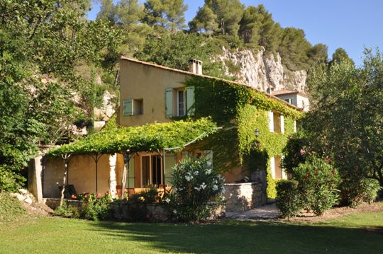 View of the restored old barn villa La Bergerie at the Moulin de la Roque, stunning cliff of the forest